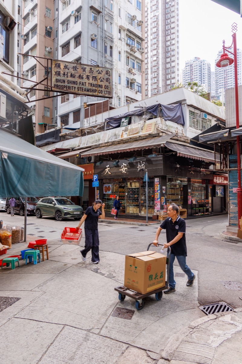 Busy streets filled with people, vehicles and bright signs in the central urban area of the city