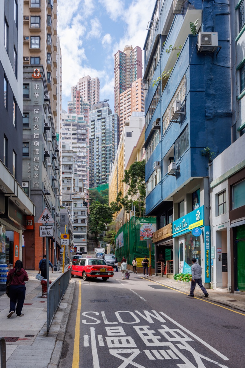 Busy streets filled with people, vehicles and bright signs in the central urban area of the city