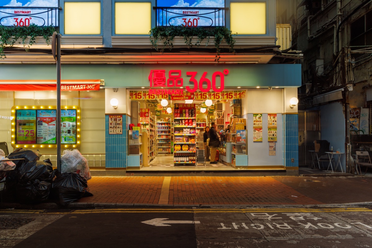 Busy streets of the city in the early evening with people, traffic and bright lights