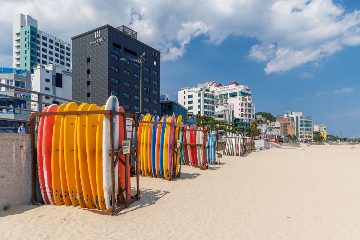 Haeundae Beach with hotels, apartment towers and the modern skyline of Busan along the coast.