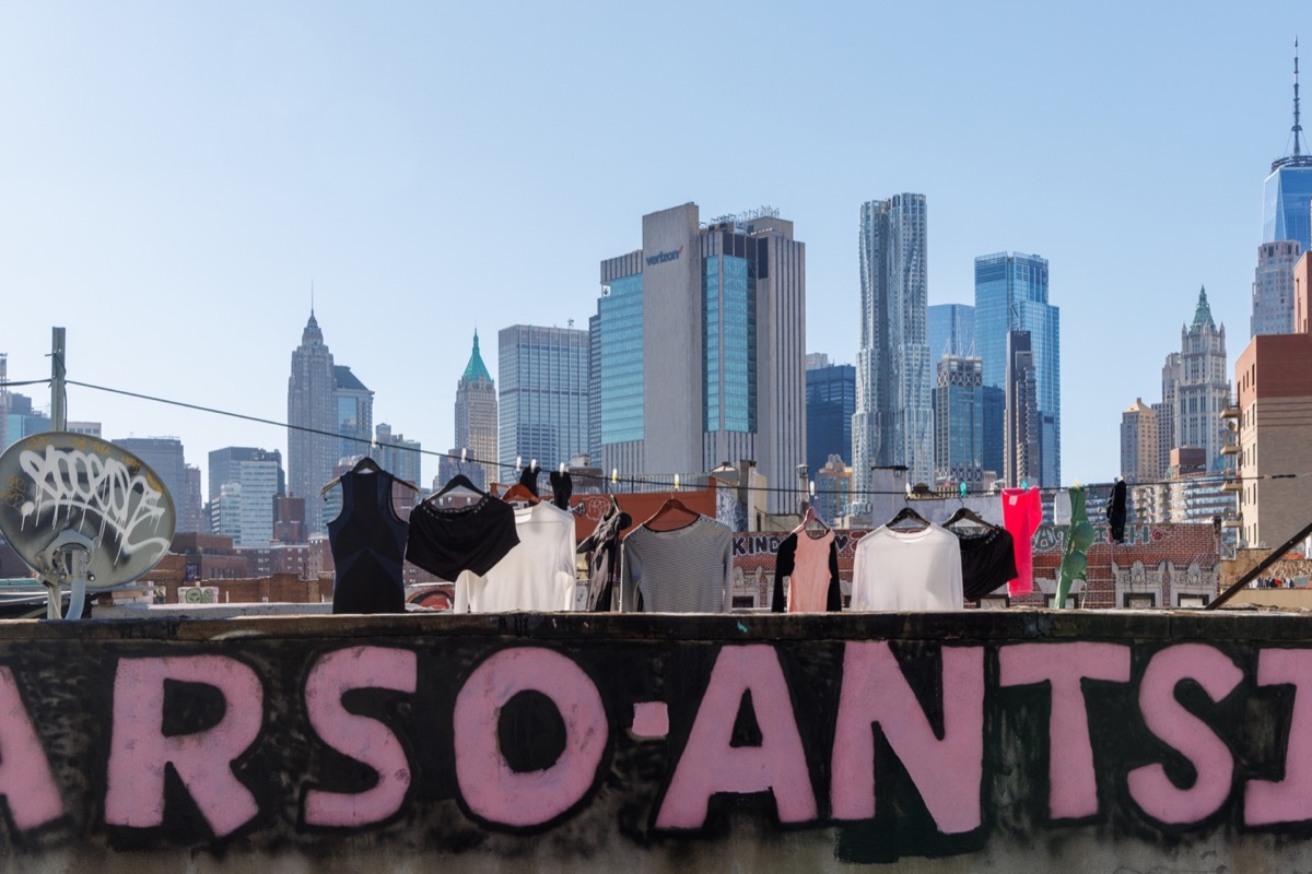 Manhattan skyline behind a weathered sign