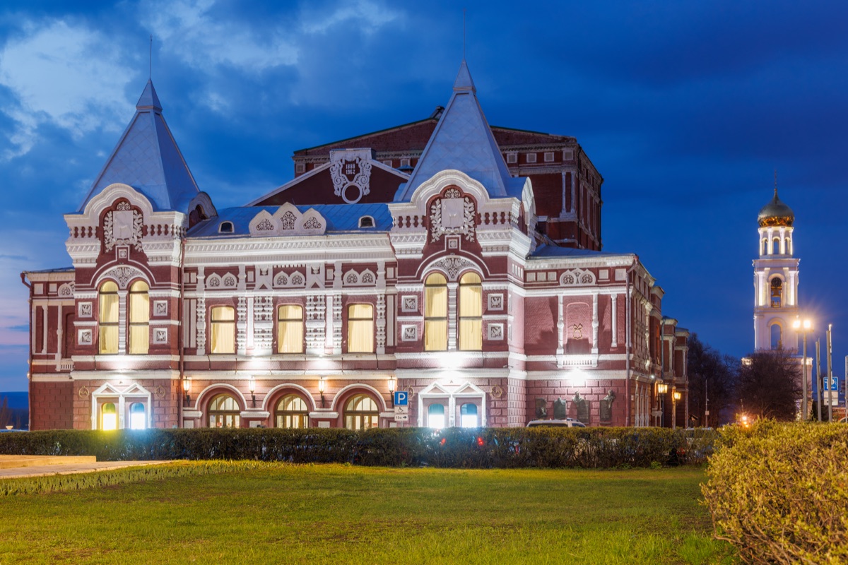 Drama theater in Samara, Russia, at sunset, lit by warm golden light with classical architecture