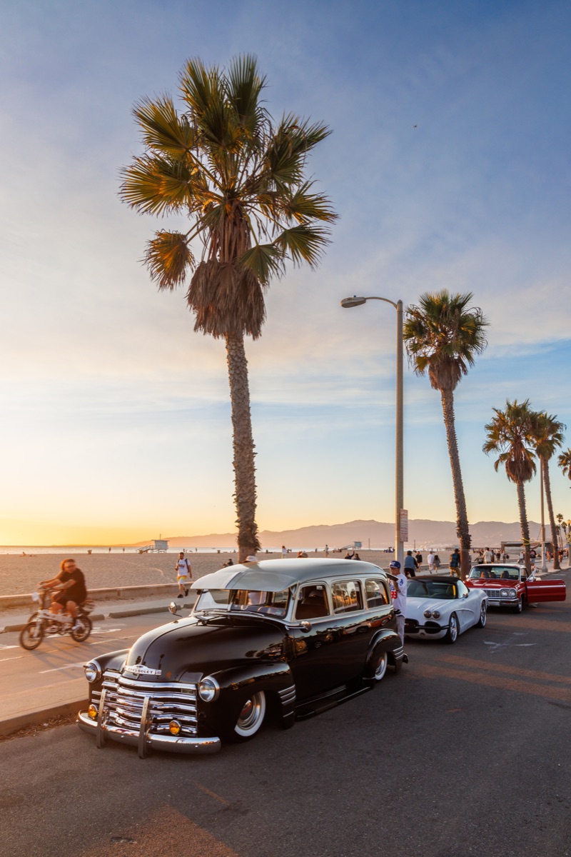 Retro cars parked near the beach in Los Angeles on a beautiful summer sunset day